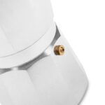 Close-up of the silver moka pot handle and safety valve