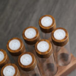 Funnel filling glass dosing tube with coffee beans