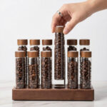 Close-up of custom engraved wooden base on coffee storage system