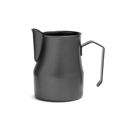 Black milk pitcher pouring foamed milk into latte